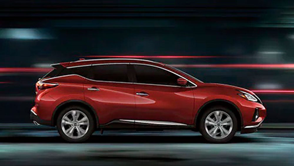 2023 Nissan Murano shown in profile driving down a street at night illustrating performance. | Old Orchard Nissan in Skokie IL
