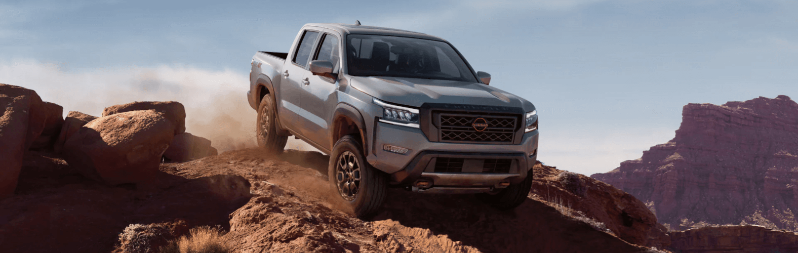 2023 Nissan Frontier on mountain with grill facing view
