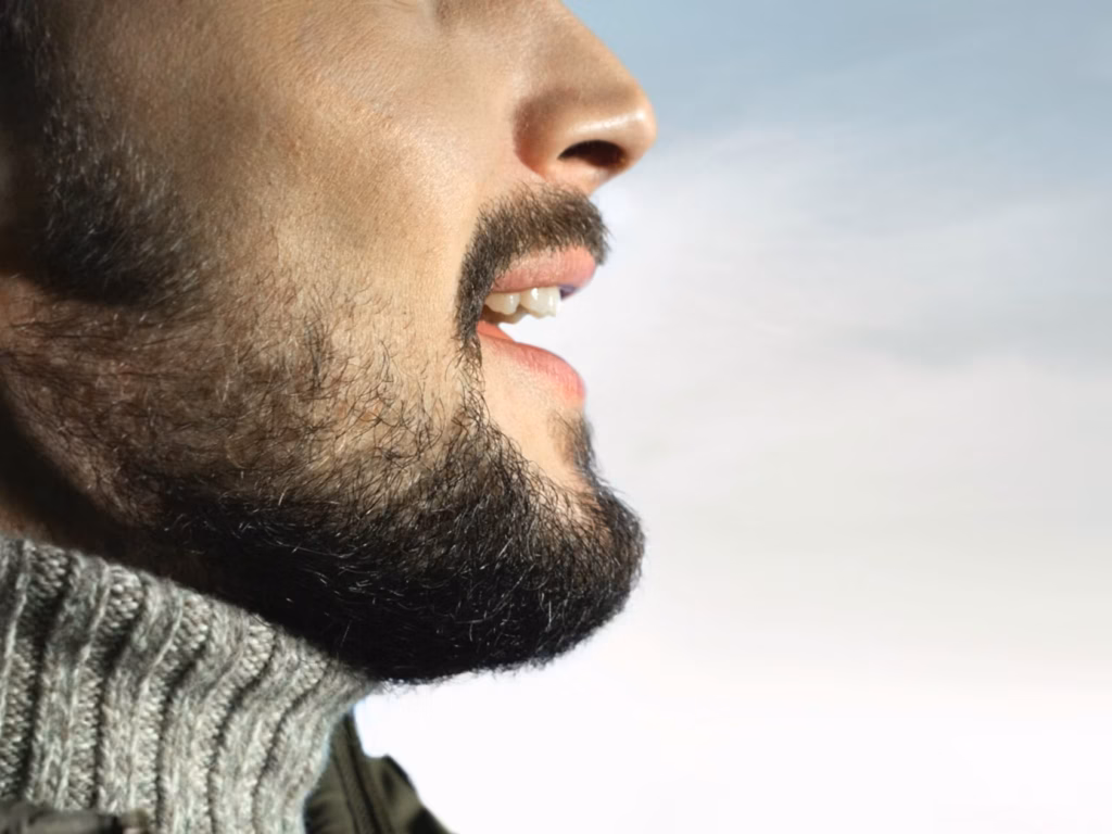 Man with Short Beard and Mustache Side Profile Side profile of a man with short beard and mustache wearing a knit collar