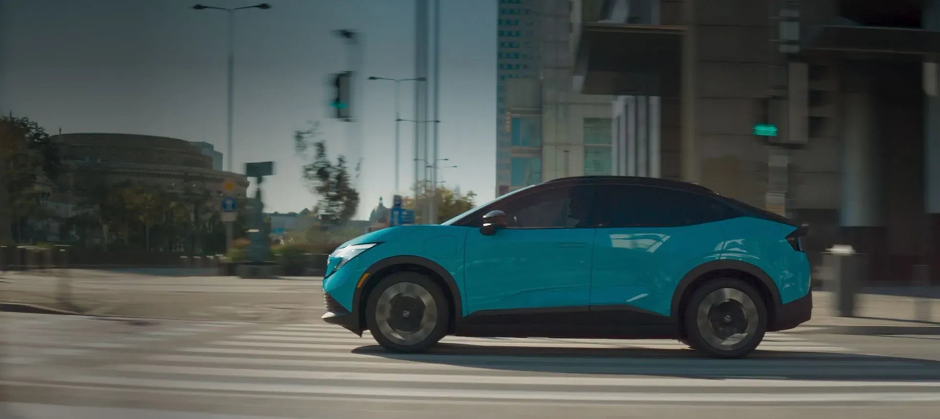 2026 Nissan LEAF — front three-quarter view parked outside a modern home