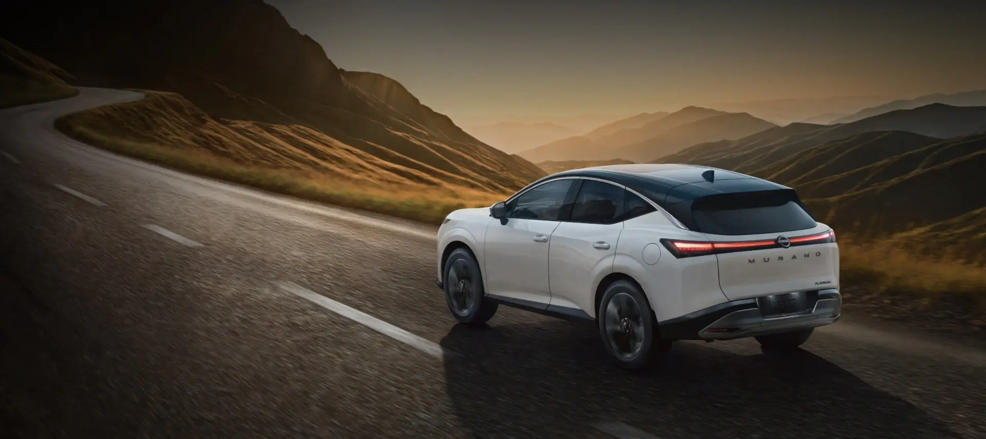 2027 Nissan Murano Platinum Exterior 2027 Nissan Murano Platinum — rear three-quarter view on a mountain road