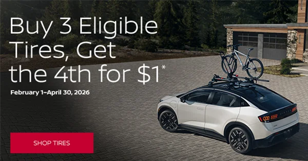 Buy Three Tires Get Fourth For One Dollar Promotion Car with roof bicycle next to tire promotion banner