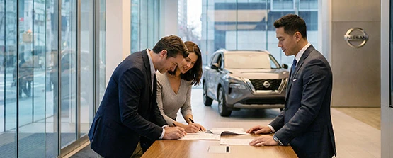 Nissan Purchase Agreement Signing Process Customers signing paperwork at Nissan dealership
