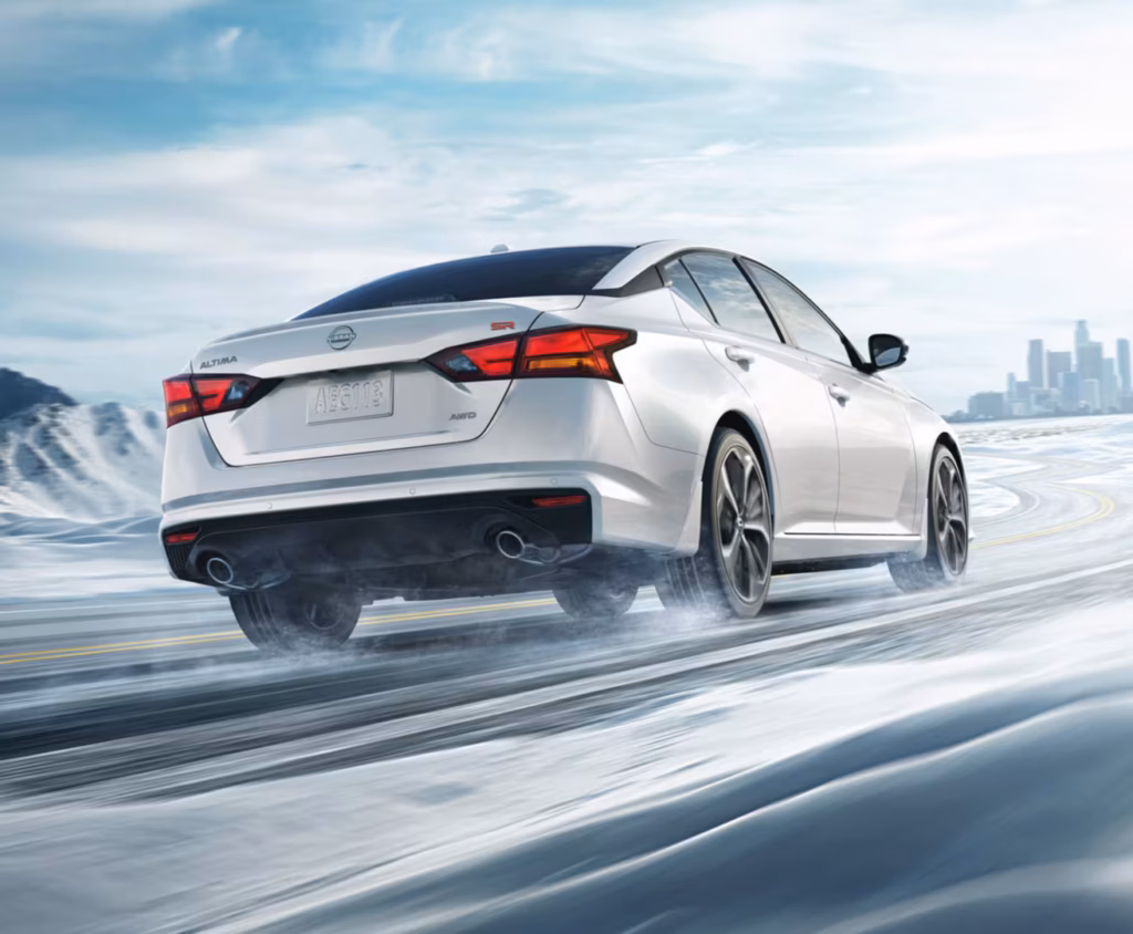 White Nissan Altima SR AWD Driving on Snowy Road White Nissan Altima SR AWD driving on snow-covered road