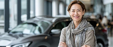 Satisfied customer standing inside car dealership