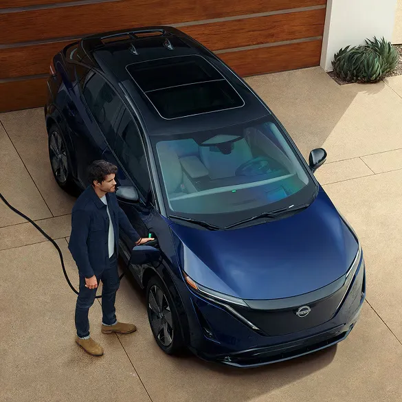 Nissan Ariya Home Electric Vehicle Charging Man charging nissan ariya electric suv at home