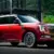 Red Nissan Armada SUV parked near modern home