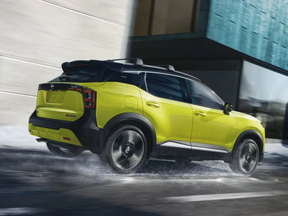 Yellow Nissan SUV in Dynamic Urban Drive Lime green Nissan compact SUV driving through a modern city street in motion
