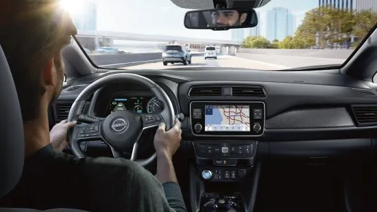 Nissan Interior Navigation Display While Driving Driver viewing navigation screen inside nissan vehicle