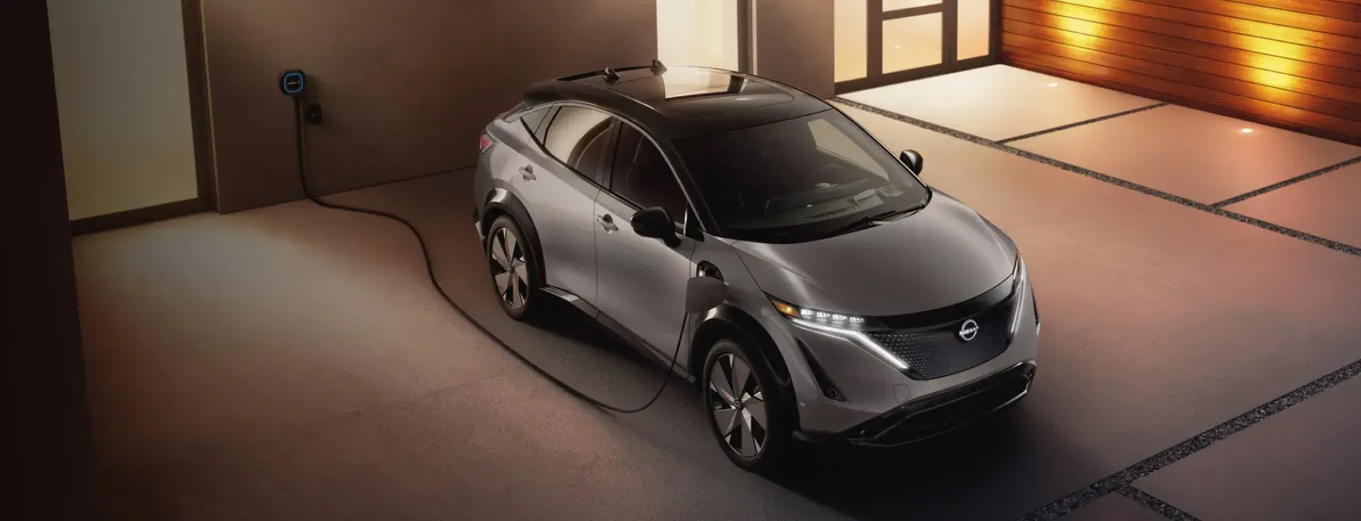 Nissan electric SUV charging in a home garage