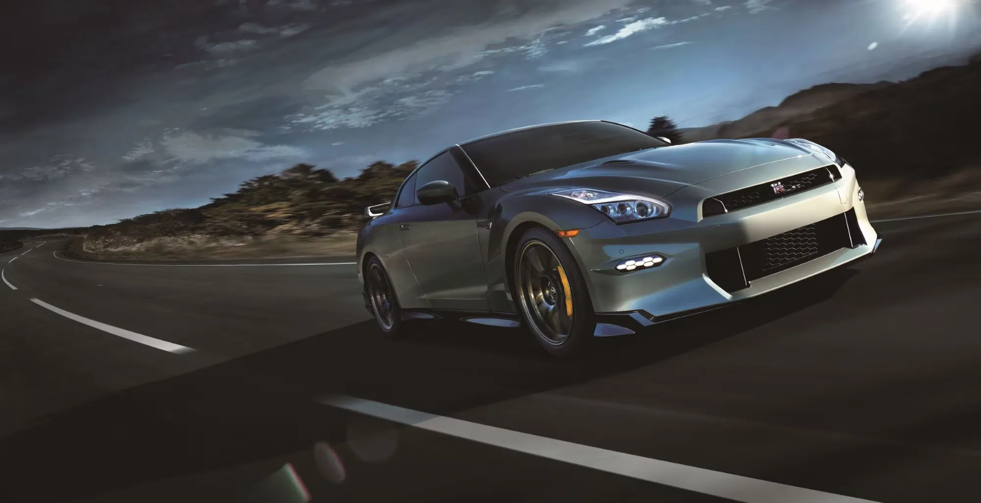 Nissan GT-R on Open Highway Front angle view of Nissan GT-R driving on a curved road