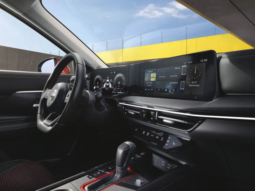 Nissan Interior with Digital Dashboard and Infotainment Display Nissan vehicle interior showing steering wheel, digital instrument cluster, center touchscreen, and gear selector