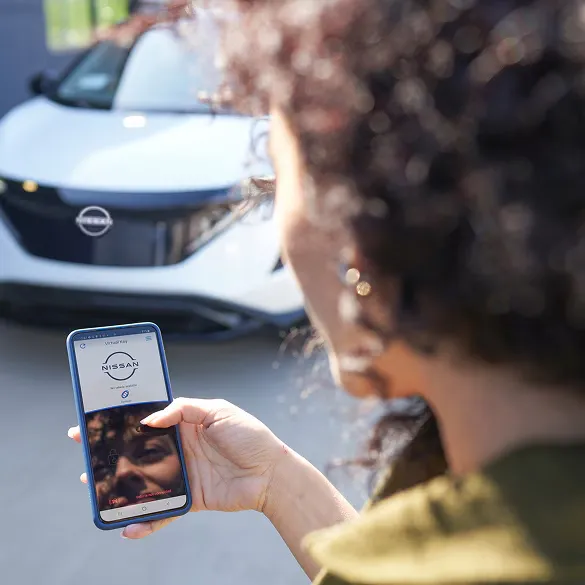 Nissan Remote Vehicle Access via Mobile App Person using nissan mobile app to access vehicle