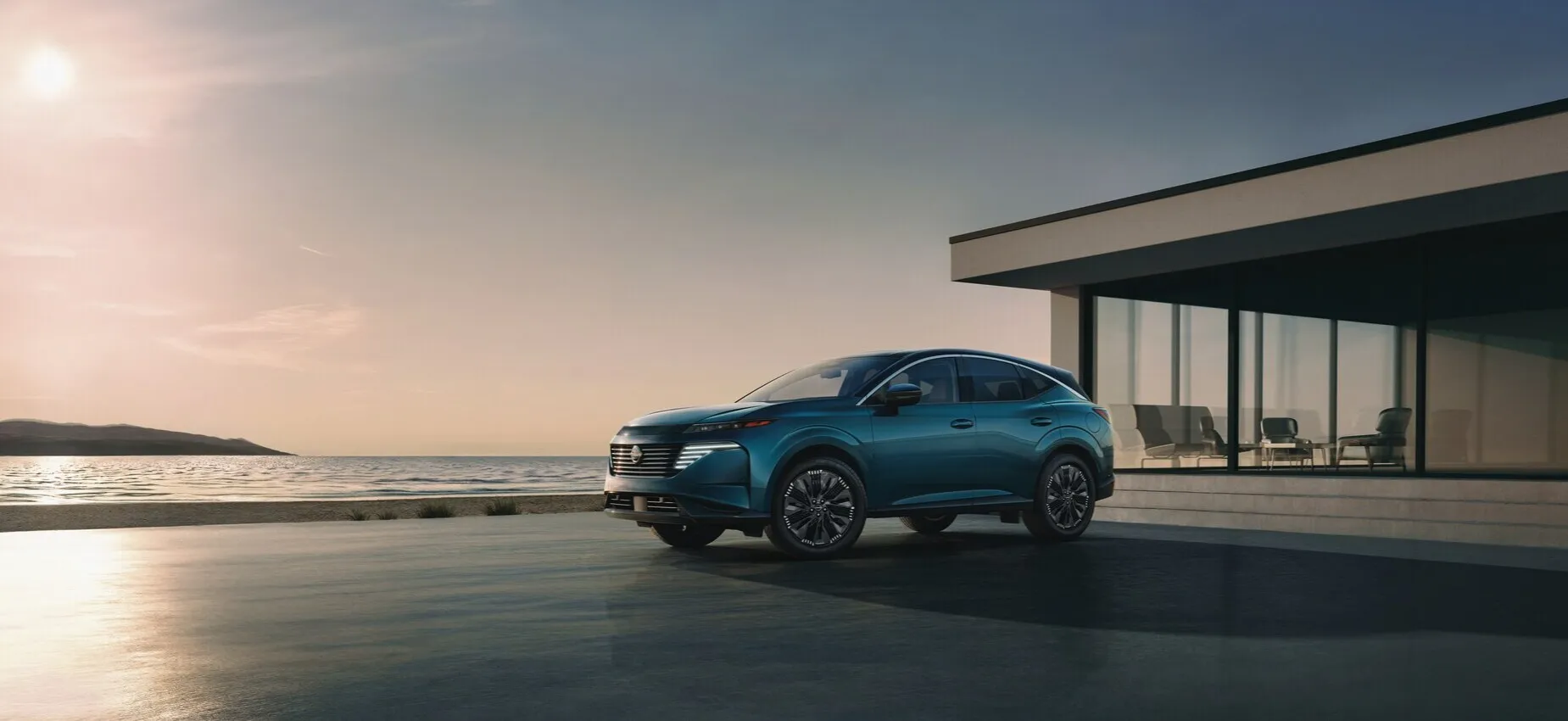 Nissan Murano SUV parked near modern coastal home at sunset