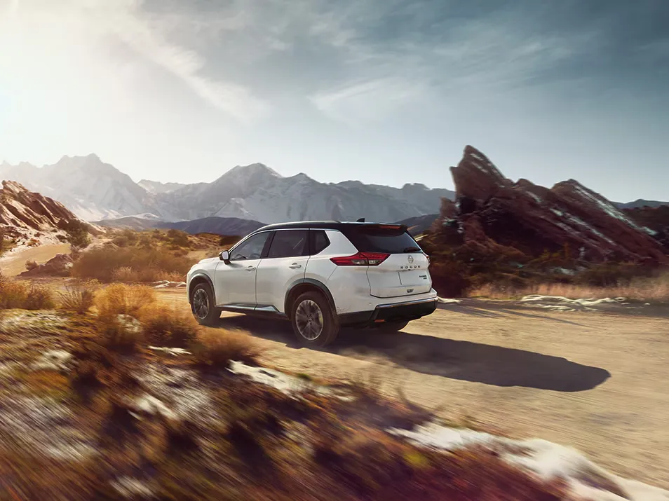 Nissan SUV Adventure Driving On Mountain Road Nissan SUV driving on a scenic mountain road, showcasing capability, stability, and confidence for outdoor adventures