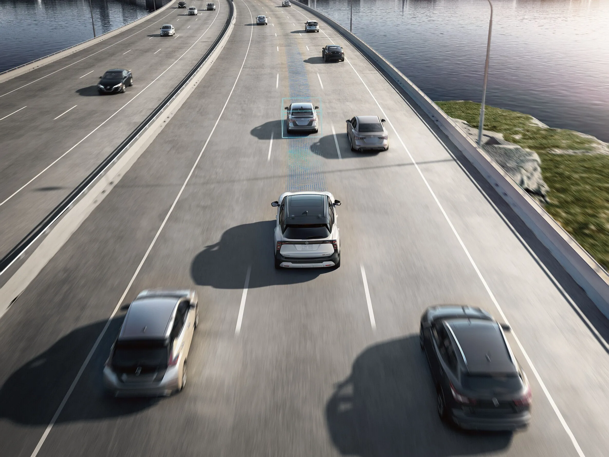 Nissan SUV Driving on Multi-Lane Highway with Surrounding Traffic Nissan SUV driving in traffic on a multi-lane bridge with other vehicles and visible lane markings