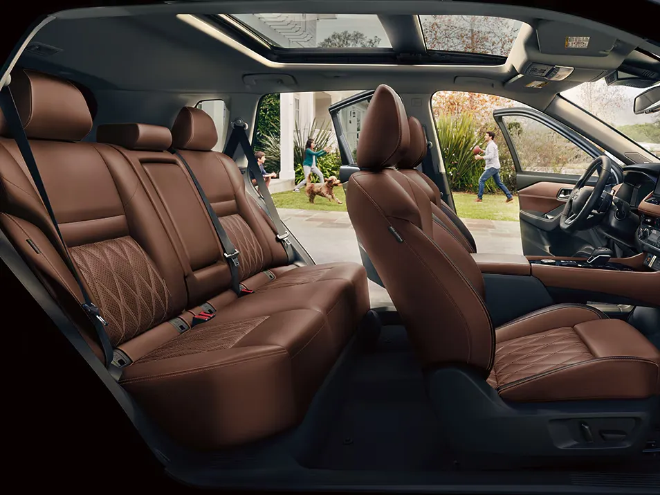 Nissan SUV Premium Leather Interior With Family Comfort Brown leather interior of a Nissan SUV with spacious seating, panoramic sunroof, and family activity visible outside