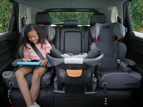 Nissan SUV Rear Seat Child Safety Child riding safely in rear seat with installed car seats in a Nissan SUV interior