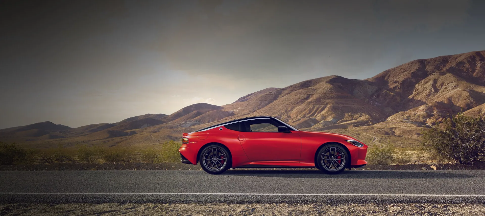 Red Nissan Z Coupe on Mountain Road
