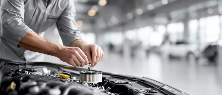 Automotive Technician Replacing Engine Air Filter During Maintenance Hands removing and installing engine air filter in a vehicle engine bay